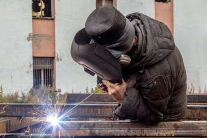 A worker welding metal